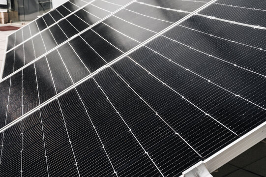 cells of a black solar panel in closeup. Renewable green Energy system