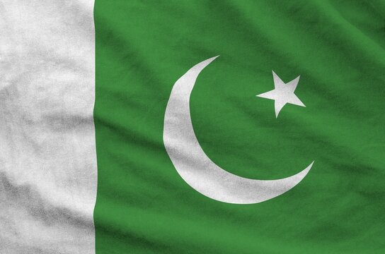 Pakistan flag depicted on folded wavy fabric of old cloth close up