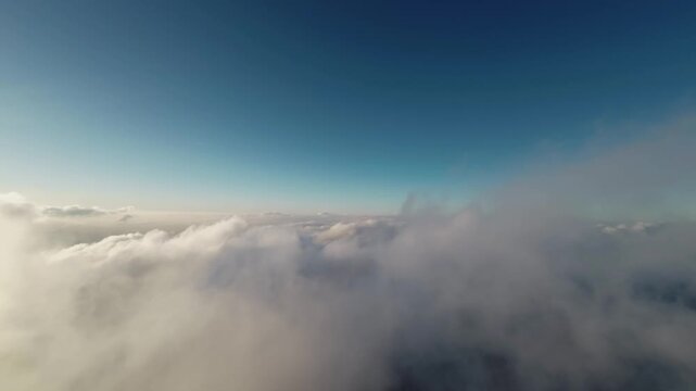 Sunset Aerial fpv view Real flight in the clouds first-person view from the cockpit. Cloud surfing in sunny weather. Aerial view flying through the clouds