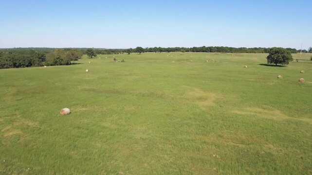 Drone footage of hay bales in a rural Oklahoma pasture