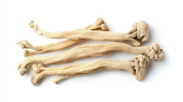 Cluster of dried ginseng roots isolated on a white background, photographed from above. The clean and minimalist setup emphasizes the natural contours.