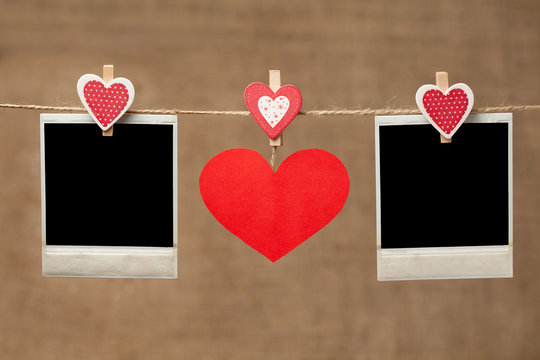 Two polaroid photo frames and red heart for valentines day on vi