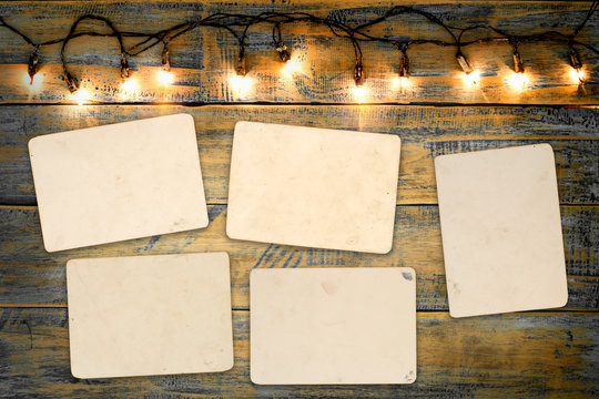 Blank photo frame album - empty old instant photos paper on wood table in christmas. vintage and retro style