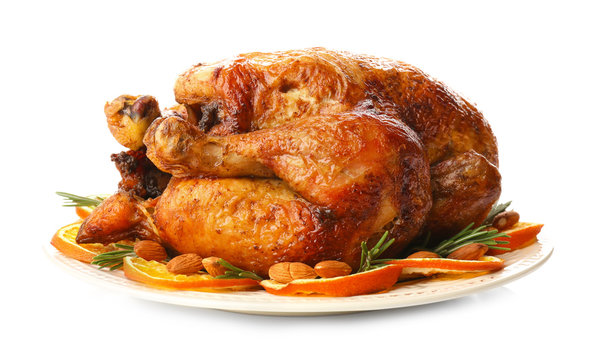 Plate with roasted turkey on white background