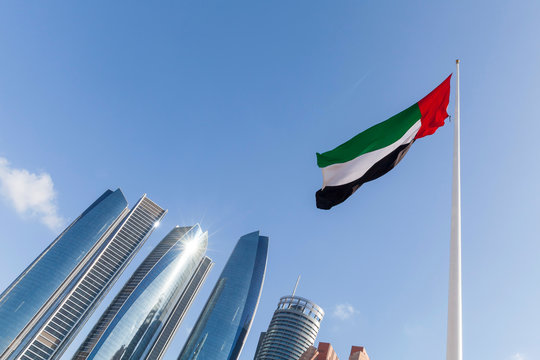 UAE flag waving in the sky, national symbol of UAE