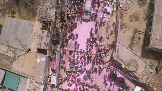  Huge crowd celebrating Holi festival in Vrindavan, India,  4k aerial drone 