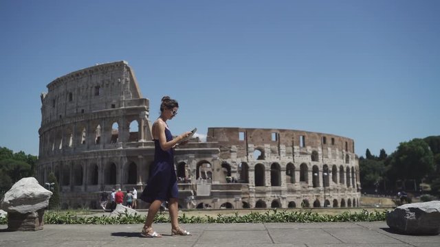 Young woman walking through Rome with map. 4K