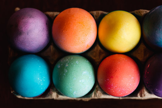 High angle close up of brightly colored Easter eggs.