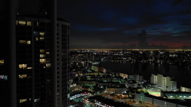 Aerial descent building in foreground and city in background 4k