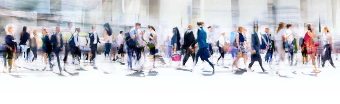 Walking people blur. Lots of people walking in the City of London. Wide panoramic view of people crossing the road. 