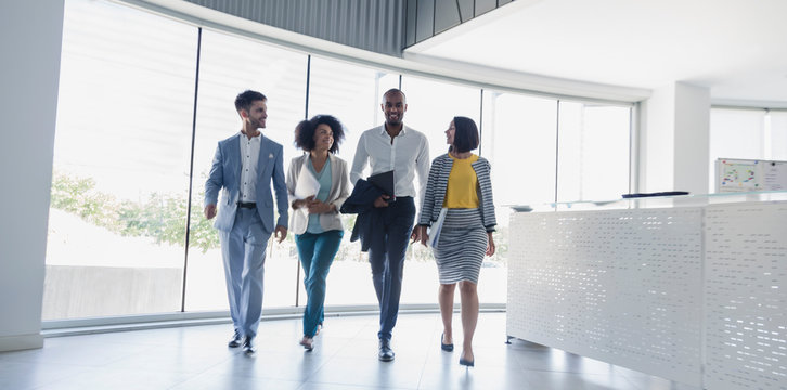 Business people walking in office lobby