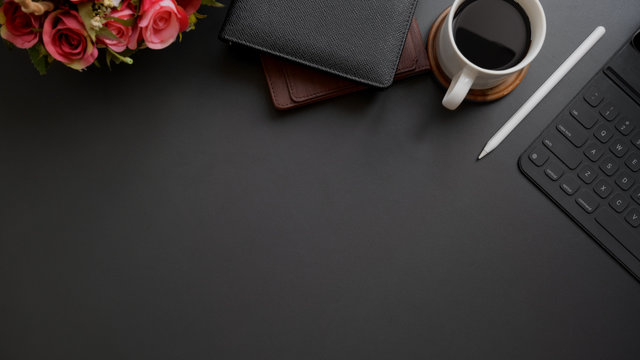 Top view of dark modern workplace with copy space on black table background