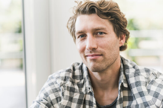 Smiling man sitting at home