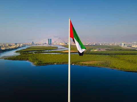 UAE flag and Ras al Khaimah emirate in the north United Arab Emirates aerial skyline landmark view