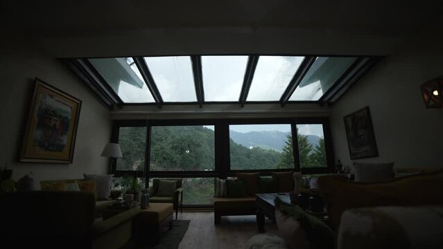 Timelapse shot of the blue sky and moving clouds, trees, nature from window of a house room situated in Himalayan hills of India. High-quality 4k footage