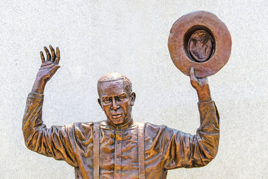 2021-07-20 Tulsa OK USA - Bronze sculpture from actual photograph taken during Race Massacre of 1921 standing in Reconciliation Park in downtown Tulsa of man with hands up holding hat in the ai