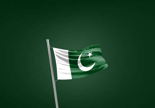 Pakistan flag waving in the wind on flagpole.