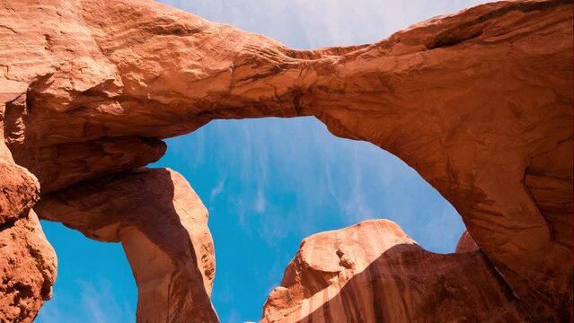 Low-angle footage of stone arches in Moab city under the blue sky