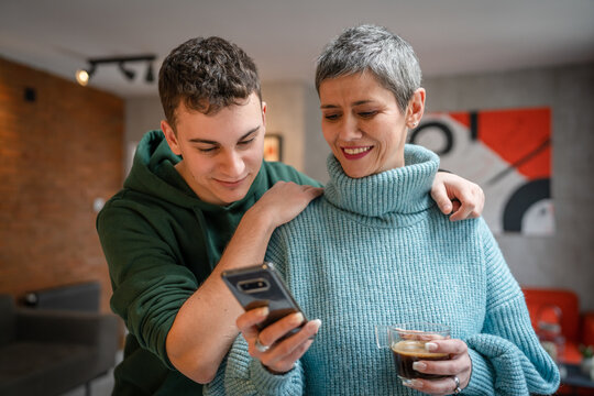 teenager boy young man and mature woman mother and son take selfie photos self portraits at home