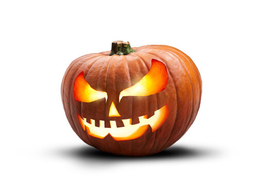 A single lit spooky halloween pumpkins, Jack O Lantern with evil face and eyes isolated against a transparent background.