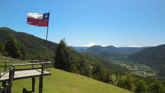 Drone view of Chilean flag and Villarica volcano in the beginning of route to Heart lagoon laguna corazon in Chile.