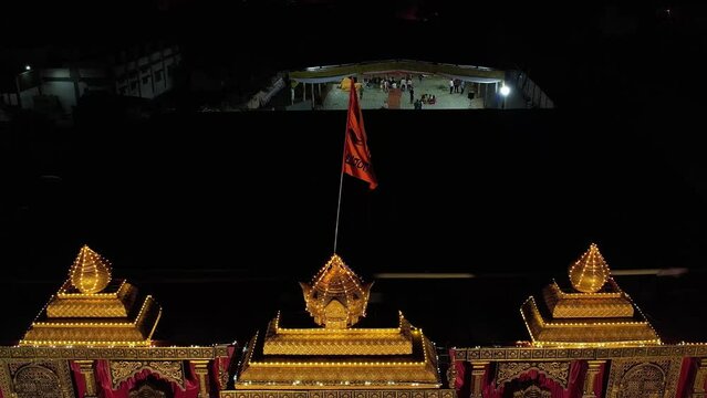 A drone shot of a Hindu saffron flag fluttering on top of a stage during event