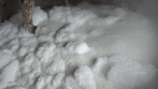 Add water to boil the tofu. traditional tofu making