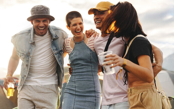 Young people celebrating summer with drinks amid festival vibes