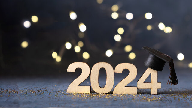 Class of 2024 concept. Number 2024 with graduated cap and bokeh lights banner.