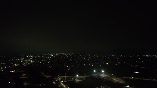 Night view of fireworks in dark sky over illuminated city