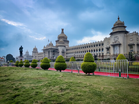 The Vidhana Soudha stands as a symbol of architectural splendor and political heritage under the watchful eyes of the monsoon sky.