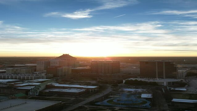 Aerial footage towards the sunset during the golden hour over the Greensboro, NC skyline