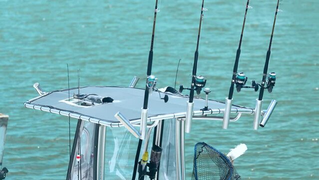 Saltwater fishing rods on boat with ocean in background