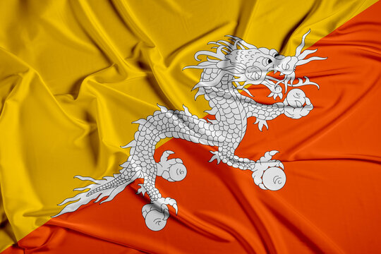 Bhutan official national flag of silk fabric texture. Waving Fabric Flag of Bhutan