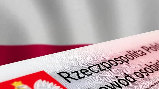 Close-up of Polish identity card and Polish flag in the background