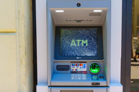 Barcelona, Spain - July 16, 2024: ATM Machine With Damaged Screen Showing ATM Text