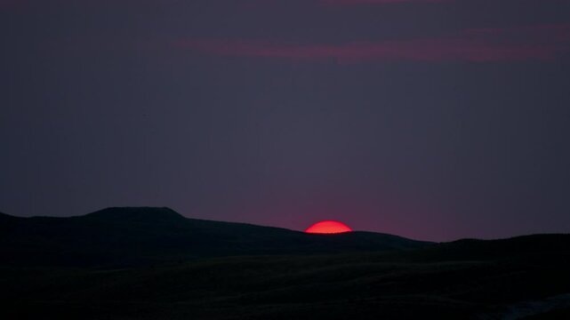 Closeup footage of a sundown into the mountain 