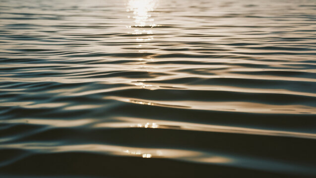 background image of sea water with soft waves and reflection of sunlight