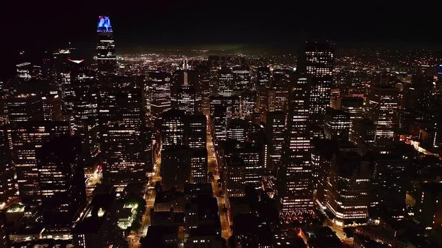 Drone footage of San Francisco skyline at night with the city lights in California