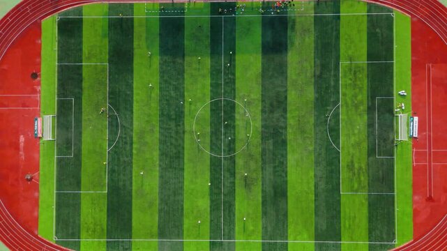 Drone view from top of soccer field with football player. Football stadium. Outdoor sports