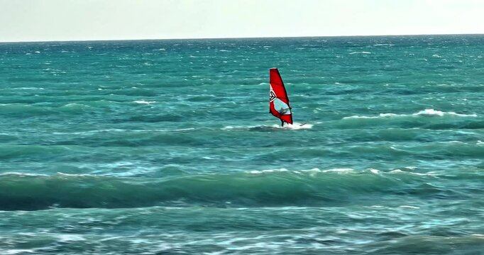 Drone Footage of Windsurfing in the Sea - Board with Sail Gliding Over Ocean Waves. High quality 4k footage