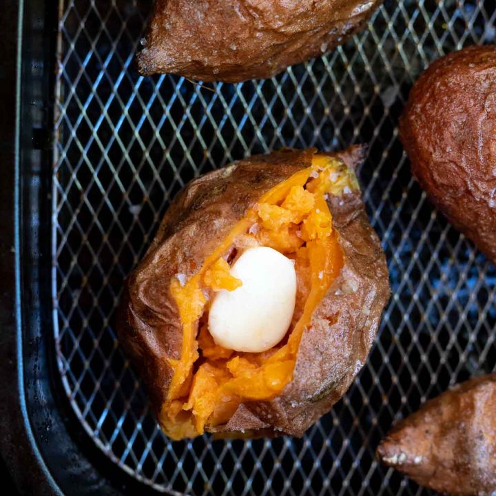 sweet potatoes filled with butter in air fryer basket