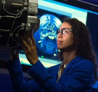 female engineer inspecting a piece of aerospace machinery