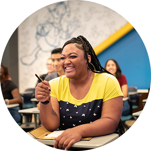 A student laughing at her desk