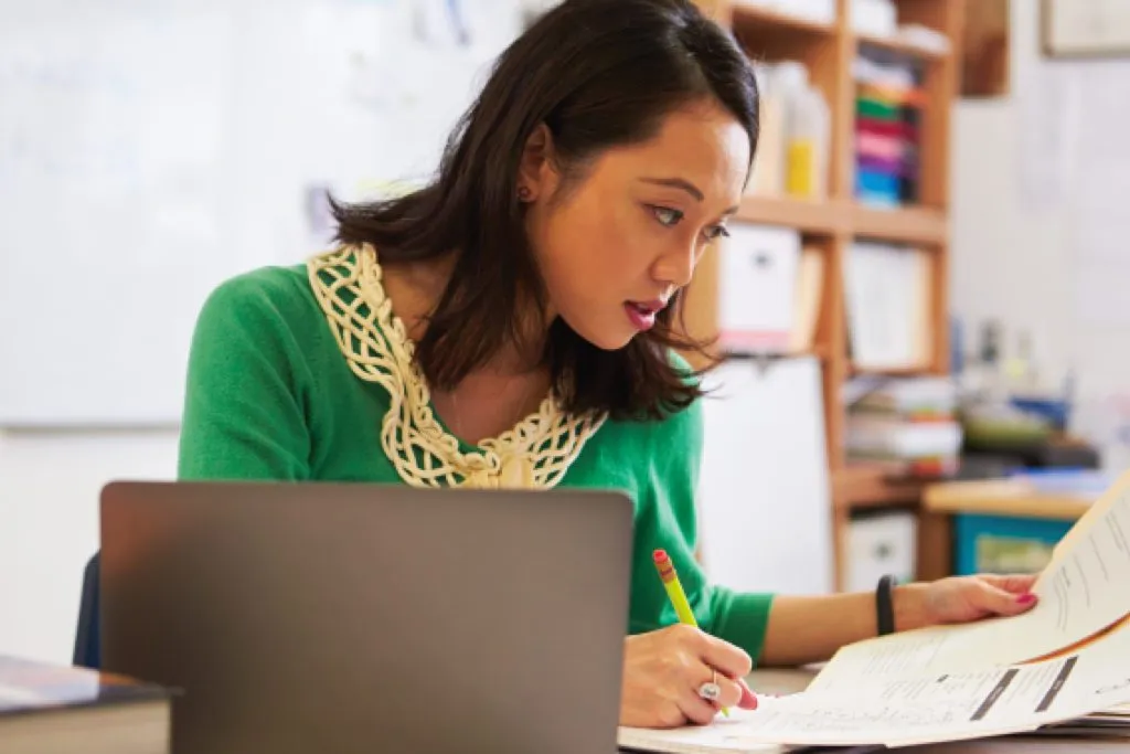 teacher in classroom preparing for class