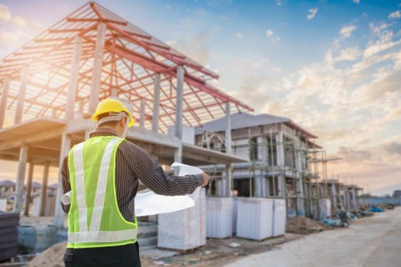 worker looking at plans at construction site