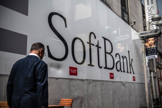 A man walks past a SoftBank building.