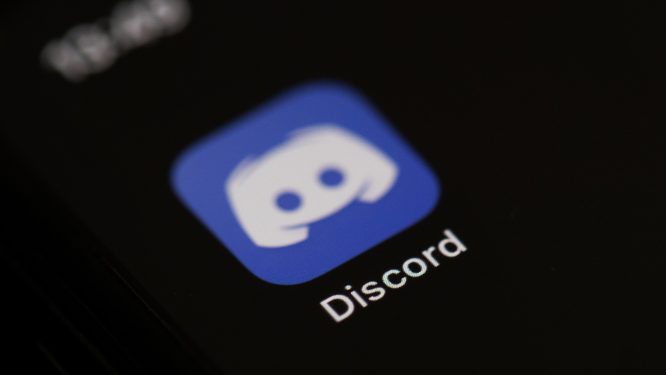 The logo of the social network application Discord on the screen of a phone.