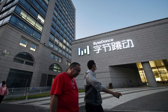 People walk past the headquarters of ByteDance, the parent company of video sharing app TikTok, in Beijing on September 16, 2020. - Silicon Valley tech giant Oracle is "very close" to sealing a deal to become the US partner to Chinese-owned video app TikTok to avert a ban in the United States, President Donald Trump said on September 15. (Photo by GREG BAKER / AFP) (Photo by GREG BAKER/AFP via Getty Images)