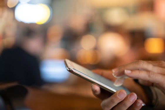 A close-up of a smartphone in its user's hands